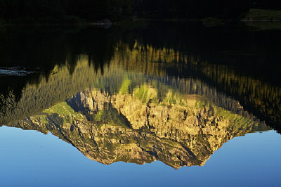 Image of Roc d'Enfer mountain reflected in Vallon lake